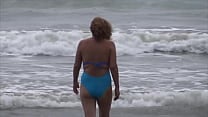 Beautiful stepmom showing off on the beach and making cocks hard