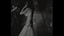 A slender brunette in an exotic costume dances excitedly on the stage of an abandoned theater A slender brunette in an exotic costume dances excitedly on the stage of an abandoned theater