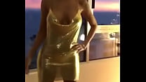 Sexy young girl is showing her sexy golden dress