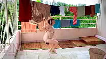 The stupid housewife hangs up the washed laundry The stupid housewife hangs up the washed laundry