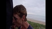 Cock blowing at the beach