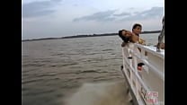 Petite brunette pleasure herself on a boat