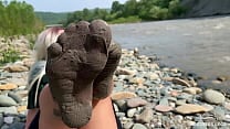 Goddess shows you her messy nylon feet close ups in torn pantyhose on the river bank