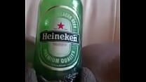 a girl mastrubating with a heineken bottle
